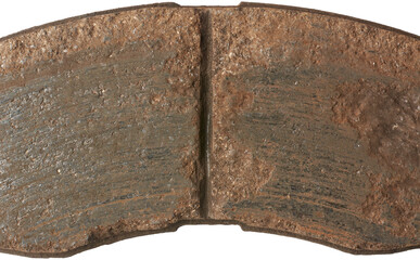 close-up top view of old worn out car disc brake pad surface, crucial components of vehicle braking...