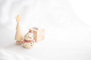 Wooden toy snowman and tree, warm white Christmas