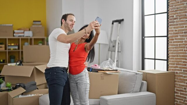 Beautiful couple make selfie by smartphone smiling at new home