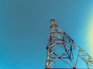 Below view of communication tower against blue sky