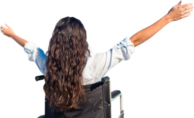 Digital png photo of back view of woman in wheelchair raising arms on transparent background