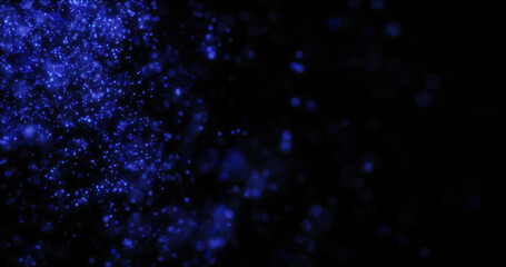 Blurred blue abstract background of bokeh and small round particles of energy magical holiday flying dots on a black background