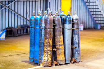 Oxygen cylinders with compressed gas. Multicolored oxygen cylinders for industry at a metal...