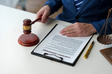 Lawyer or legal counsel holding the hammer of justice Concluded in terms of contract documents The...