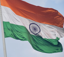 India flag flying high at Connaught Place with pride in blue sky, India flag fluttering, Indian...