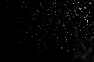 Fototapeta na wymiar Falling snow isolated on black background