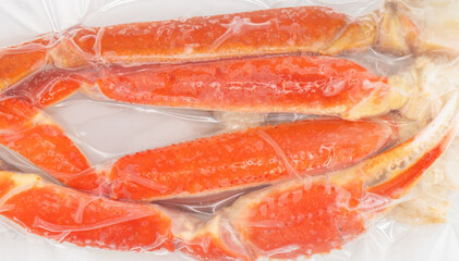 Vacuum packaged Peruvian Southern King crab leg texture background. Crab claws in vacuum package background © Aleksei
