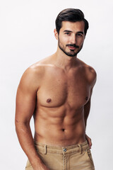 Fototapeta premium Male athlete model with naked torso and packs of abs sporty on white isolated background, trendy clothing style, copy space, space for text