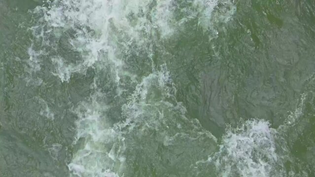 Fast flowing water in deep river. Aerial shot looking straight down. 