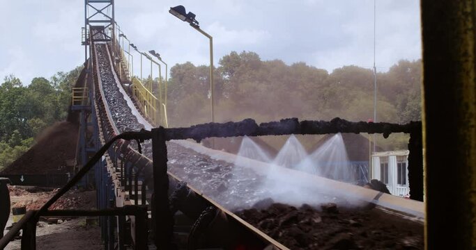 Dust Suppression System For Conveyor Belt - Spraying Water On Coal. - wide shot