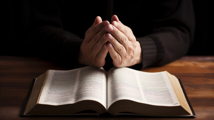 A man praying sincerely with religious book