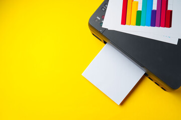 Modern printer with paper on yellow background
