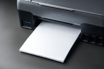 Modern laser printer on black background close up