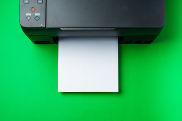Modern printer with paper on green background