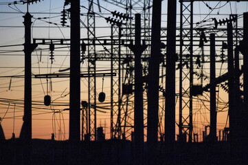 Sun-kissed circuitry: At this golden hour, the electrifying network of poles and wires basks in the...