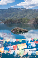 Buddhist prayer flags fluttering next to Lugu Lake in China