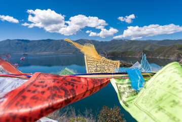 Buddhist prayer flags fluttering next to Lugu Lake in China