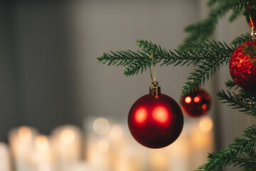Close up of res shiny balls hanging on Christmas tree