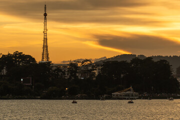 Sunset view of a Da Lat City with development buildings, transportation, market. Tourist city with center square of Da Lat city near Xuan Huong lake