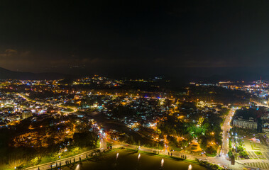 Fototapeta na wymiar Aerial panorama view of Sunflower Building at Lam Vien Square in Da Lat City. Tourist city in developed Vietnam. Center Square of Da Lat city with Xuan Huong lake