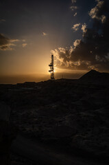 Silhouette of Oil Derrick under the Setting Sun