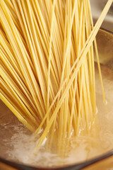 Boil pasta noodles in boiling water