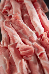 Thinly sliced frozen raw meat