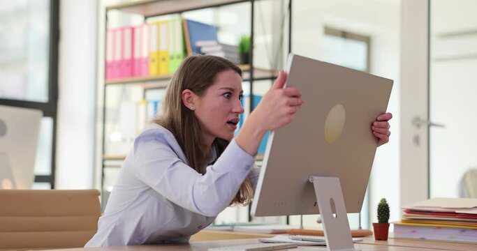 Shocked angry frustrated adult woman at work breaks computer