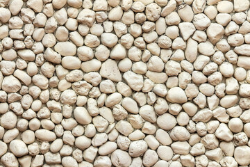 Close up shot of a beautifully textured stone wall.Typical natural stone wall, stones wall texture backdrop.Rock wall texture for pattern background. Shingle template wallpaper for designs background.