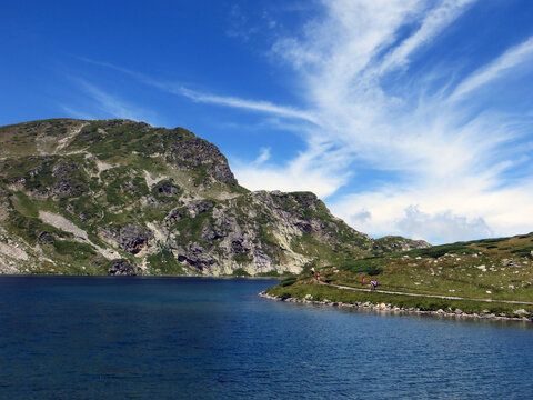 Rila, Bulgaria. August 02,2023. Summer. Sunny day. View of the mountain Rila. Tourists pass along the side of the Kidney lake (Babreka).