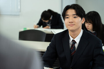 教室で勉強している制服の高校生