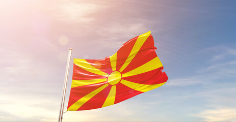 North Macedonia. national flag waving in beautiful sky. The symbol of the state on wavy silk fabric.