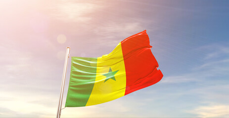 Senegal national flag waving in beautiful sky. The symbol of the state on wavy silk fabric.