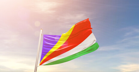 Seychelles national flag waving in beautiful sky. The symbol of the state on wavy silk fabric. - Powered by Adobe