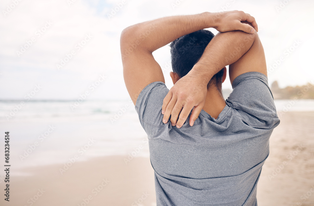 Wall mural Man, stretching and arms on beach, exercise and warm up for fitness, ready and workout by ocean. Male person, back and active in outdoors, challenge and prepare for performance, training and shore