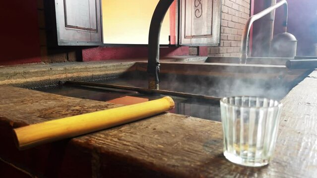 tasting mezcal in distillery for mexcal alcoholic Mexican drink production in Oaxaca mexico