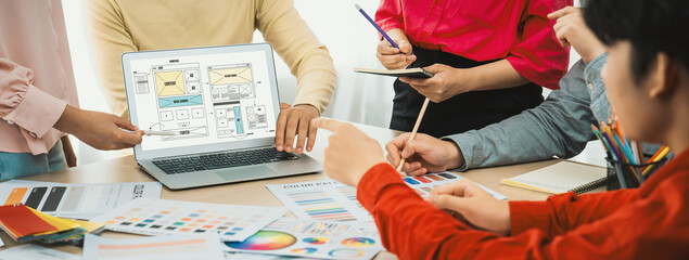 Cropped image of interior designer team discuss the material color while laptop displayed website...
