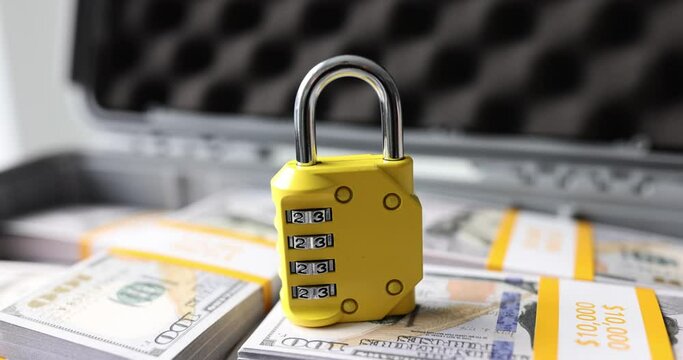 Lock with numbers on dollars in suitcase closeup. Combination lock with cipher and secure money storage