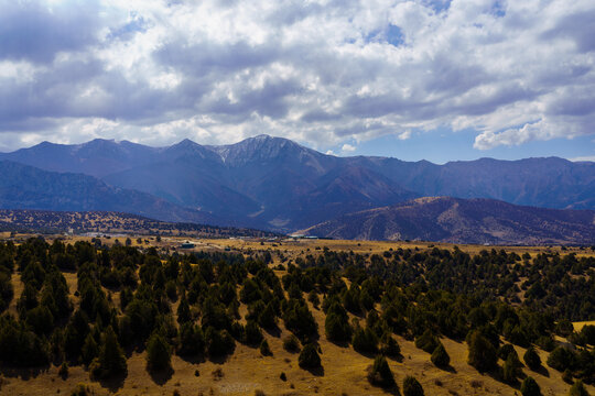 Mountains covered with grass and trees and cloudy dramatic sky on a daytime in Zaamin reserve.