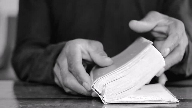 praying to God with hands on bible on table with people stock footage stock video
