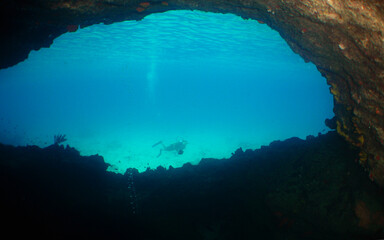 a woman diving in a cave in the caribbean sea