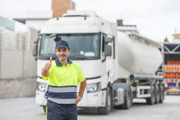 Positive male truck engineer giving thumb up approval of truck