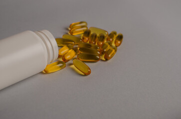 Omega-3 capsules lie in white bottle. Fish oil tablets. omega 6, 9, top view with copy space.