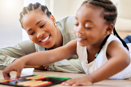 Education, smile and black woman playing with child on the floor in the living room at modern home. Abacus, mathematics and young African mother helping girl kid with counting at house together.