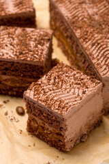 Chocolate cake cut into square pieces with nut cream