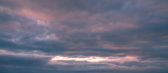 Beautiful sunset sky. Clouds at sunset. Big pink clouds, panoramic view
