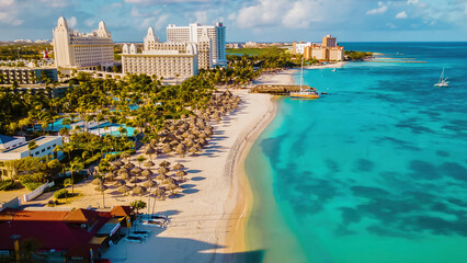 Fototapeta na wymiar Palm Beach Aruba Caribbean, white long sandy beach with palm trees at Aruba Antilles Caribbean