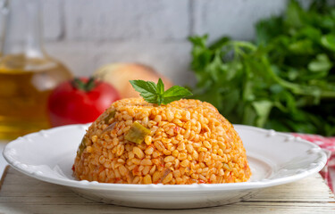 Traditional turkish bulgur pilaf with tomato sause in plate (Turkish name; meyhane pilavi)