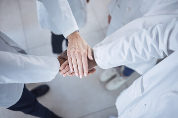 Hands, teamwork and doctors in the hospital for motivation or solidarity in medicine or healthcare. Medical, support or unity with a group of health professionals closeup in a clinic from above