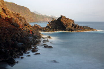 A rocky and volcanic landscape, viewed from a hiking path leading to Playa de Nogales (Nogales beach), located near Puntallana, La Palma, Canary Islands, Spain
